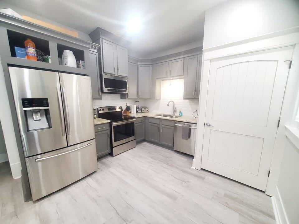 The kitchen has full size refrigerator also a stove, oven, microwave, dishwasher