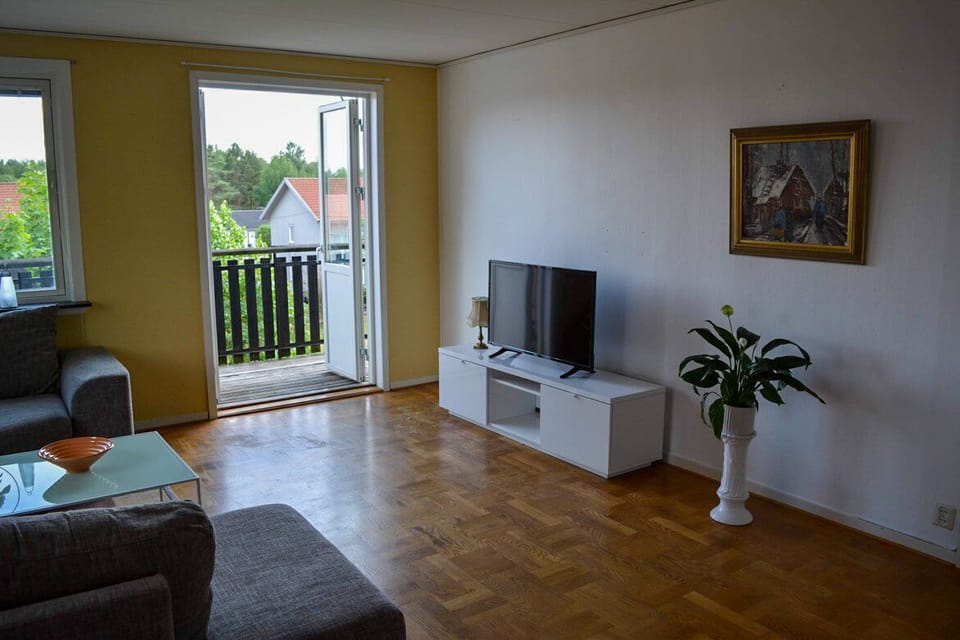 Living room with tv and a huge sofa 