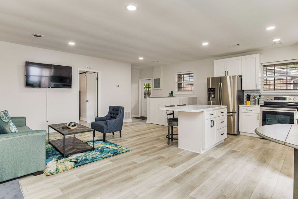 Open-concept living room with bay views at Gulf Breeze waterfront house near Pensacola