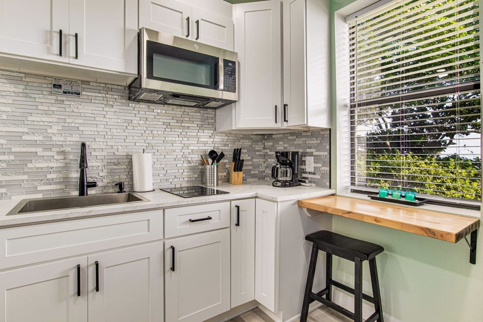Stocked kitchenette with microwave and coffee maker with Bayfront views