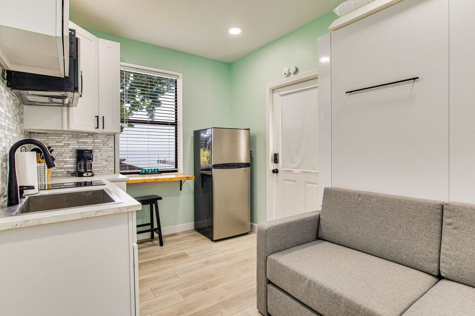 View of eating nook, kitchen and comfortable fold out couch 
