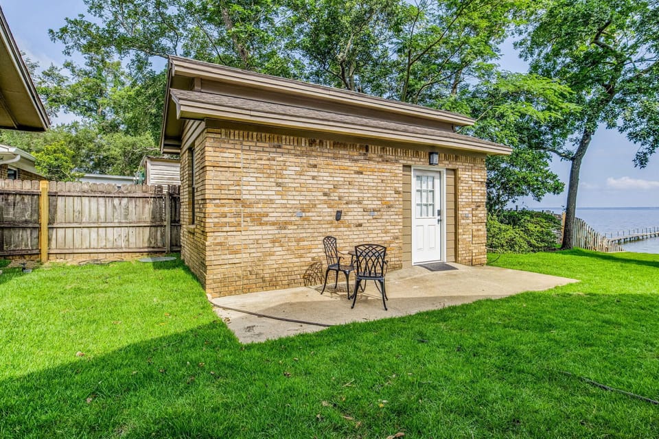 Onlooking studio unit with private patio and brick exterior
