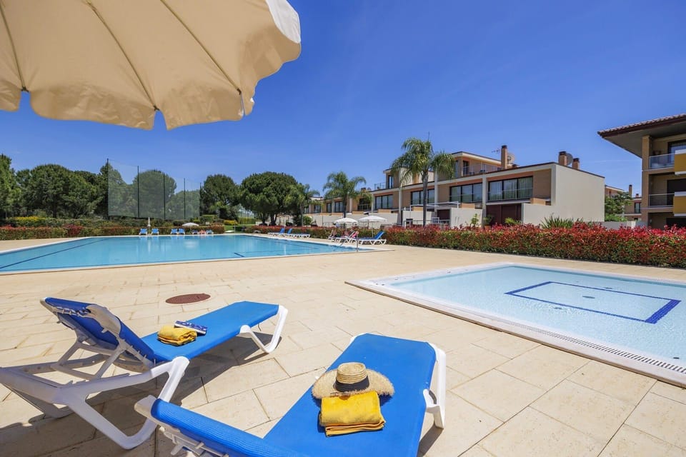 Shared Pool with sunbeds and gardens