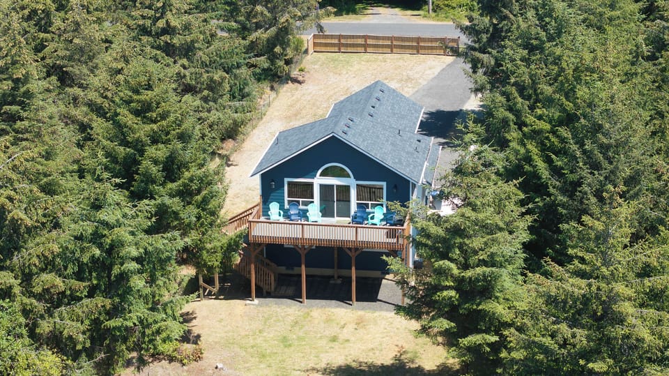 Deck with grill and adirondack chairs  