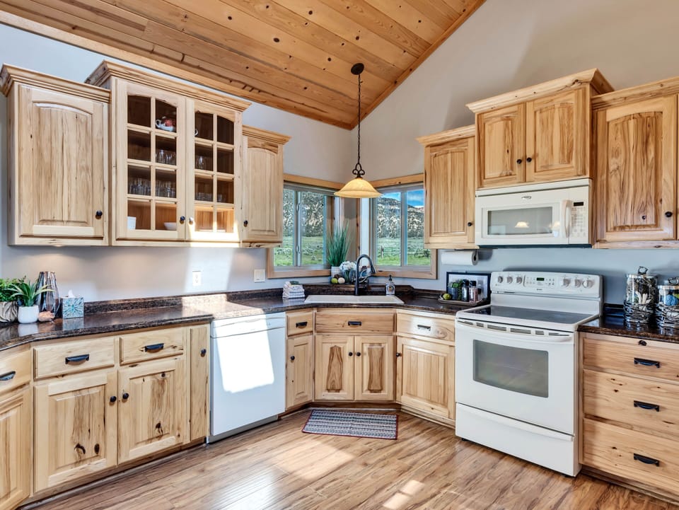 Kitchen: Charm and function unite in this sunlit space with stunning mountain views!