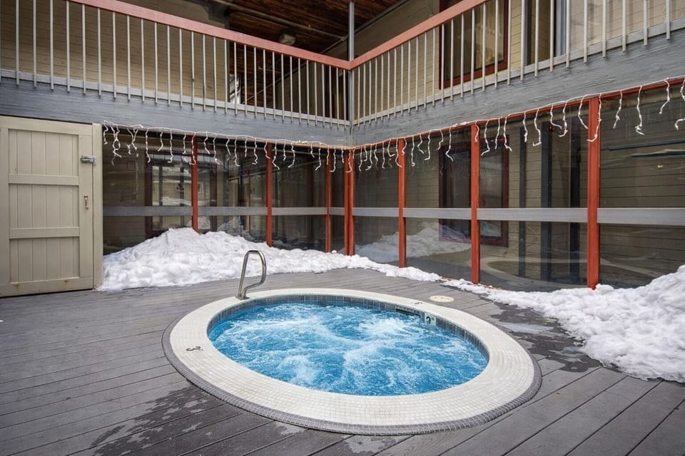 Soak under the stars in the outdoor hot tub on the deck. Surrounded by fresh snow, it's the perfect spot to unwind after a day of mountain adventures.