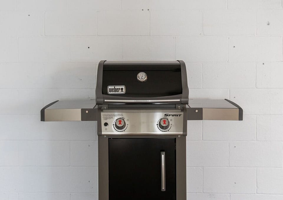 Patio also boasts a Weber grill with propane and grilling utensils included.