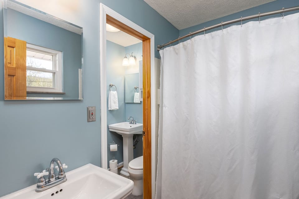 Full bath off primary bedroom with access to half bath as well