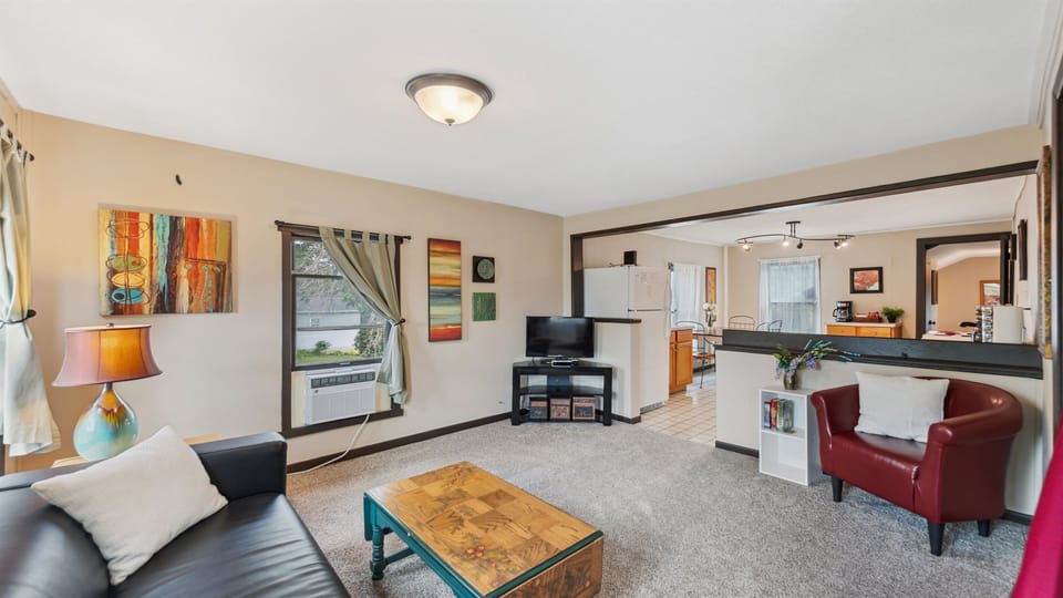 The upstairs living room leads into the kitchen, creating a wide-open space for your stay.