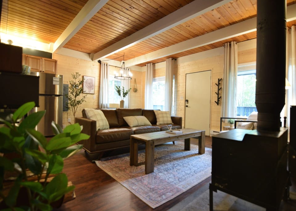 Relax and unwind in our snug living room, complete with a rustic wood-burning oven, after a thrilling day of hiking.