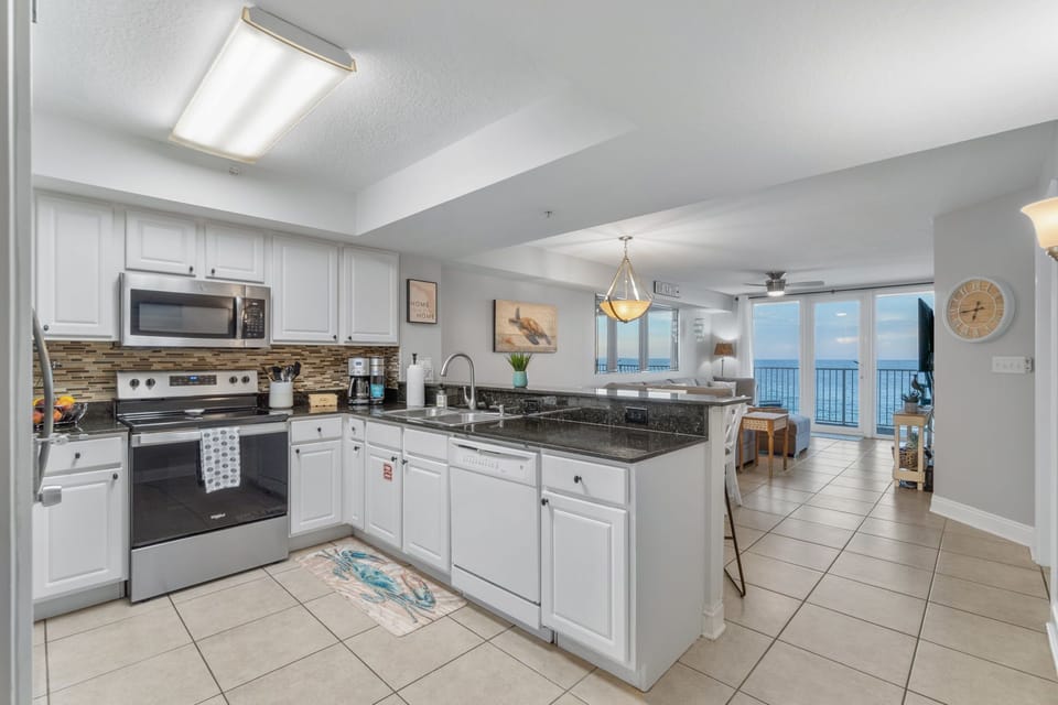 Fully stocked kitchen with view of ocean.