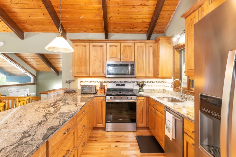 A fully-equipped kitchen with countertop seating for 4.