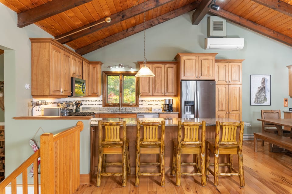 Dining area adjacent to countertop seating provides plenty of space for family meals.