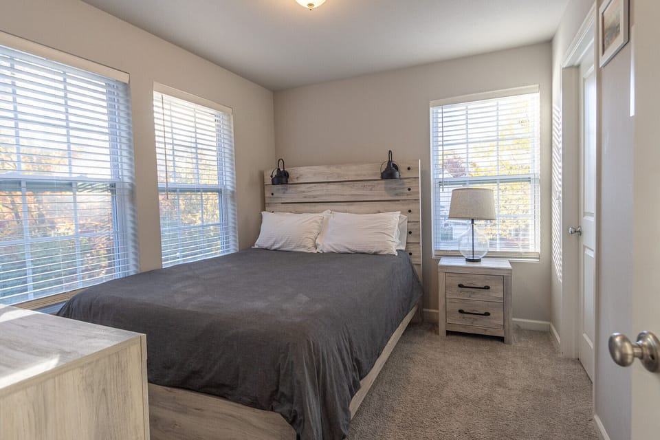 Bedroom at Harbor Pointe features a comfortable queen bed and matching furniture.