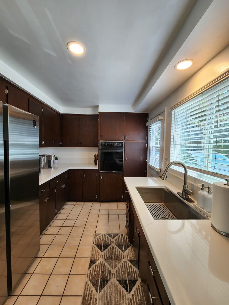 Refreshed kitchen is fully stocked with cookware and serving ware.