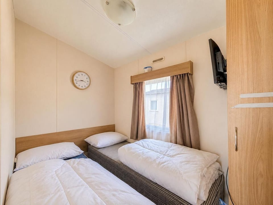 Families enjoy the twin bedroom in our holiday home bedroom during their Essex family holiday.