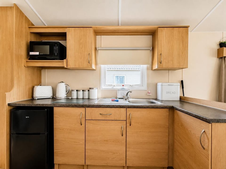 The kitchen area in the caravan is a great spot for enjoying meals with loved ones.