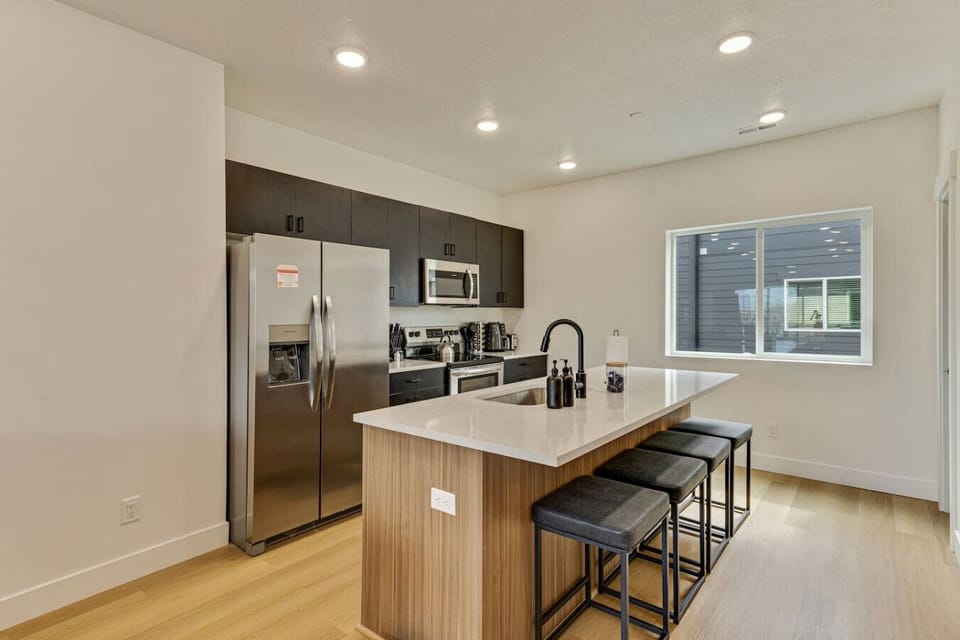 Bright modern kitchen with sleek counters, bar seating, and everything you need for home-cooked meals 🍽️☕✨