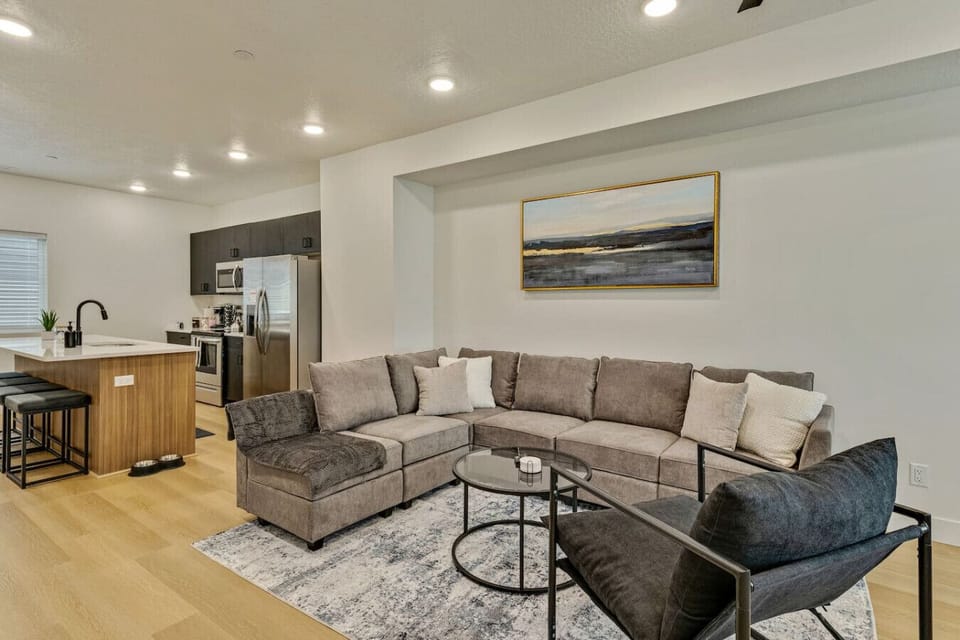 Gather in the open living area with a comfy sectional, modern kitchen, and stylish design 🛋️✨🍷