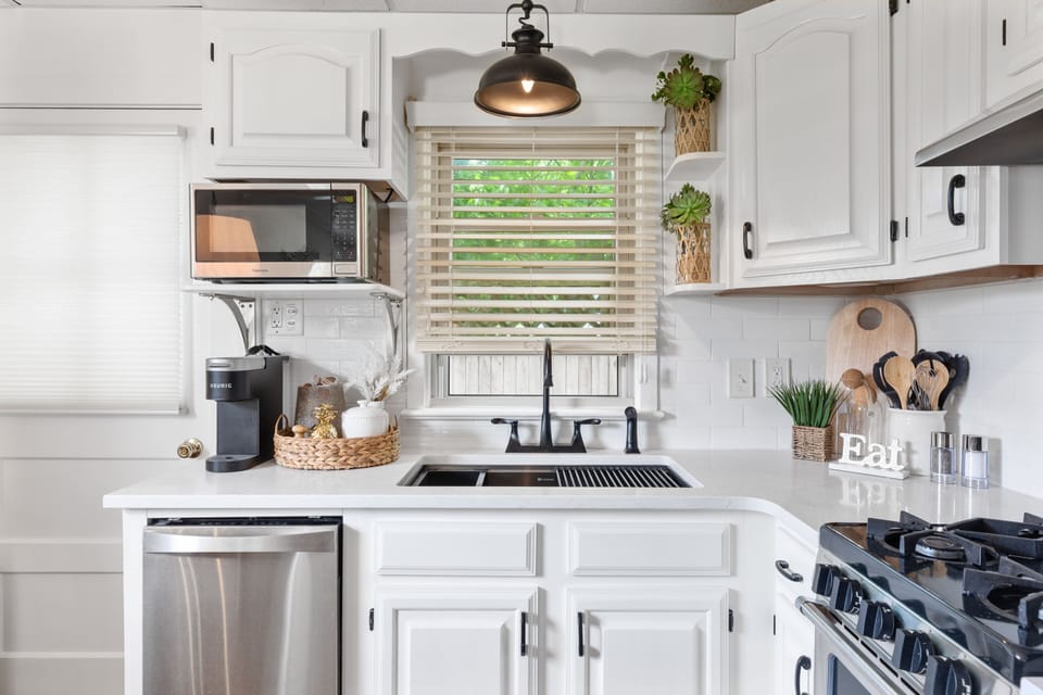 Kitchen with quartz countertops and stainless steel appliances 