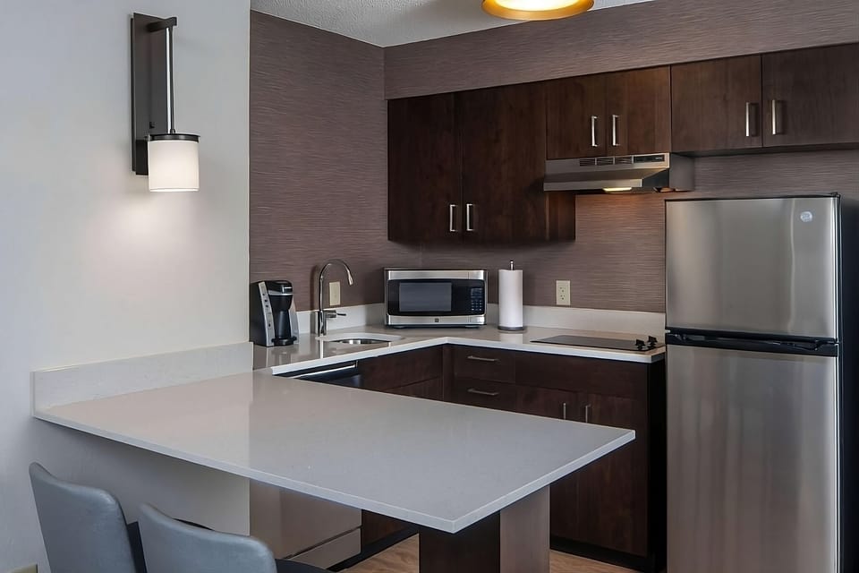 Prep quick breakfasts on clean counters with convenient kitchenette setup.