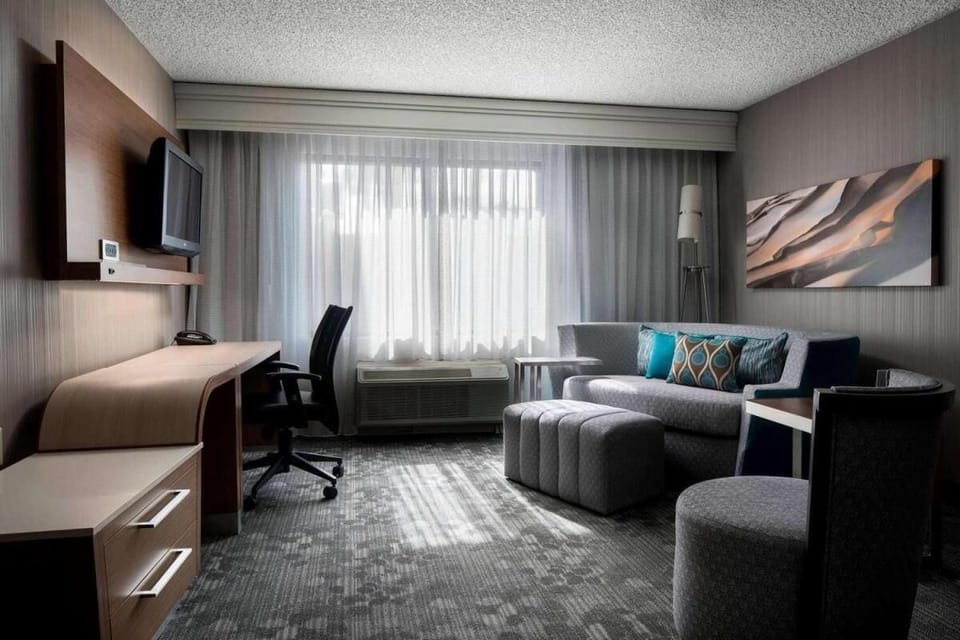 Lounge in soft seating while daylight fills the room.