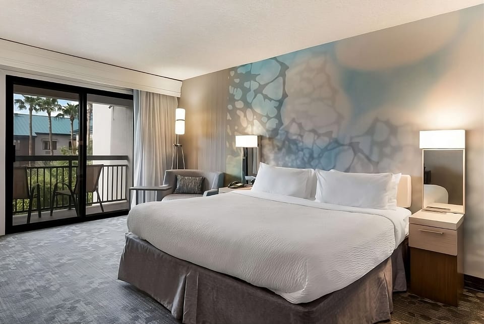 Wake up refreshed in a king room with balcony breeze.