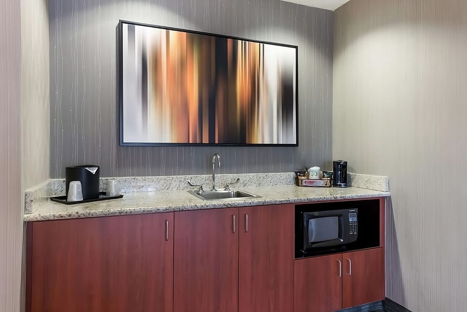 Enjoy quick snacks with sink, microwave, and coffee setup.