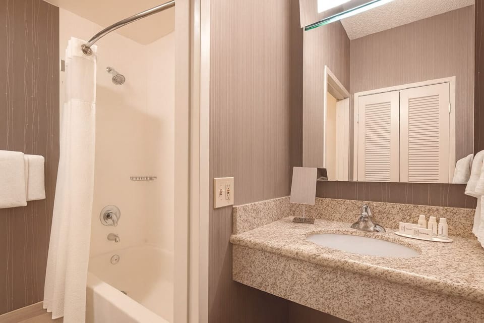 Refresh after a long day with a spotless shower-tub combo.