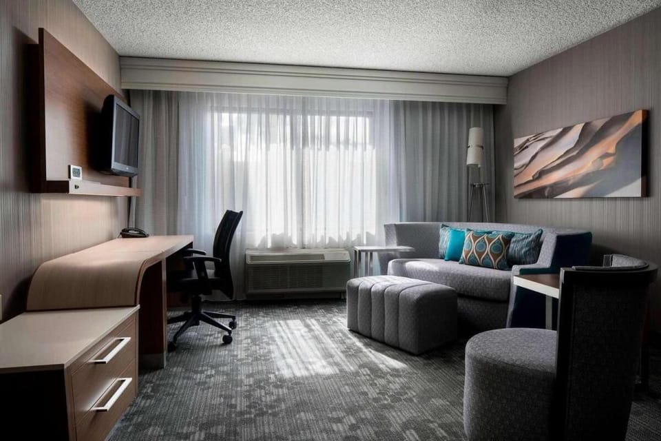Lounge in soft seating while daylight fills the room.