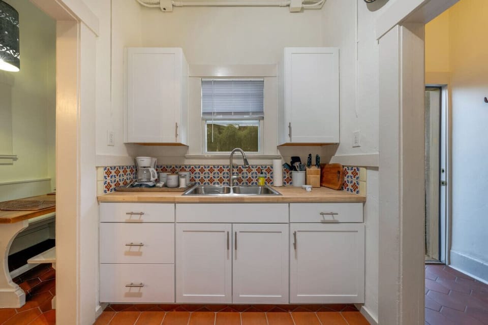 Kitchen sink with counters and cabinets stocked for your stay