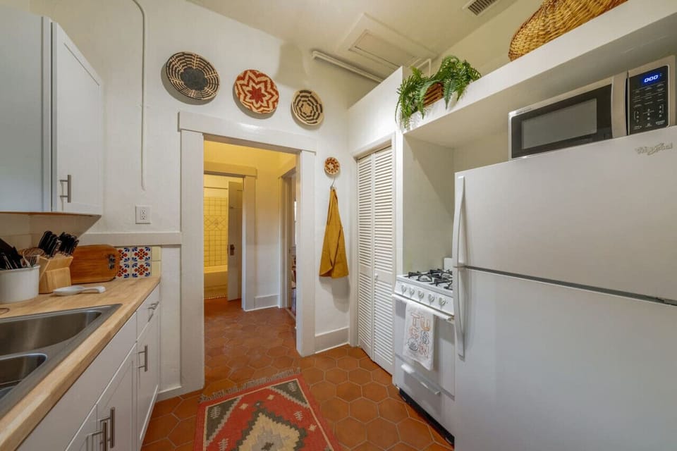 View from kitchen down the hall into bathroom