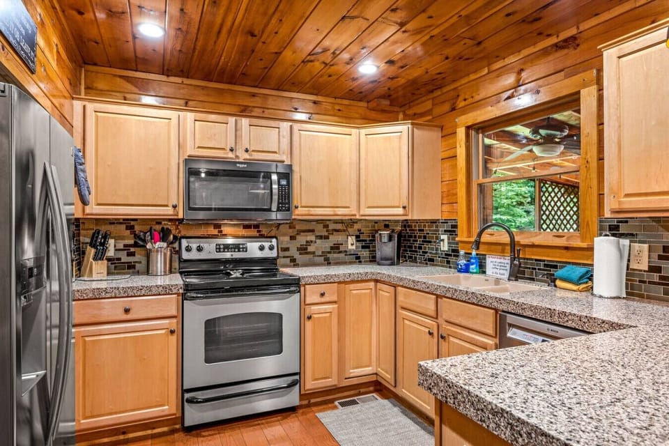 Kitchen includes a refrigerator, stove, microwave, dishwasher, pots/pans, cooking utensils, Keurig coffee maker, silverware, and more.