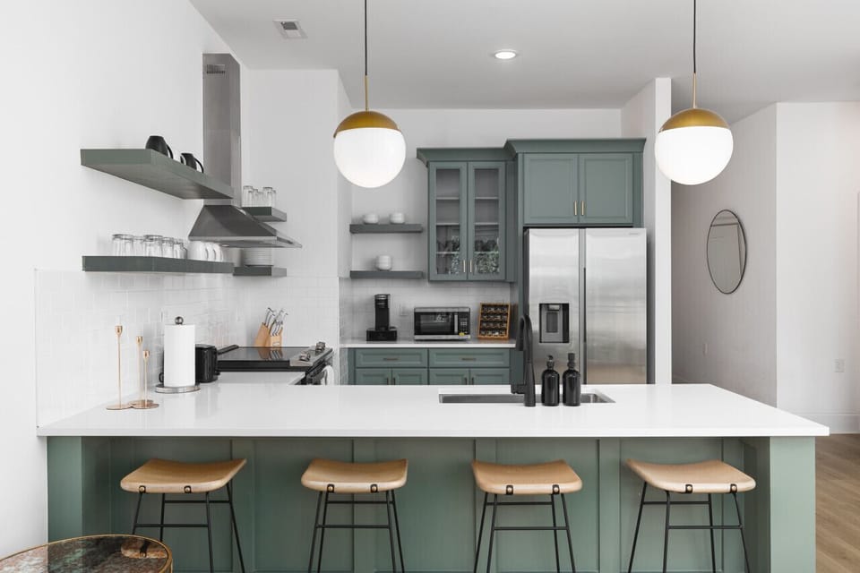 This condo was designed with ease + comfort in mind, including the warm lighting and fully-equipped kitchen.