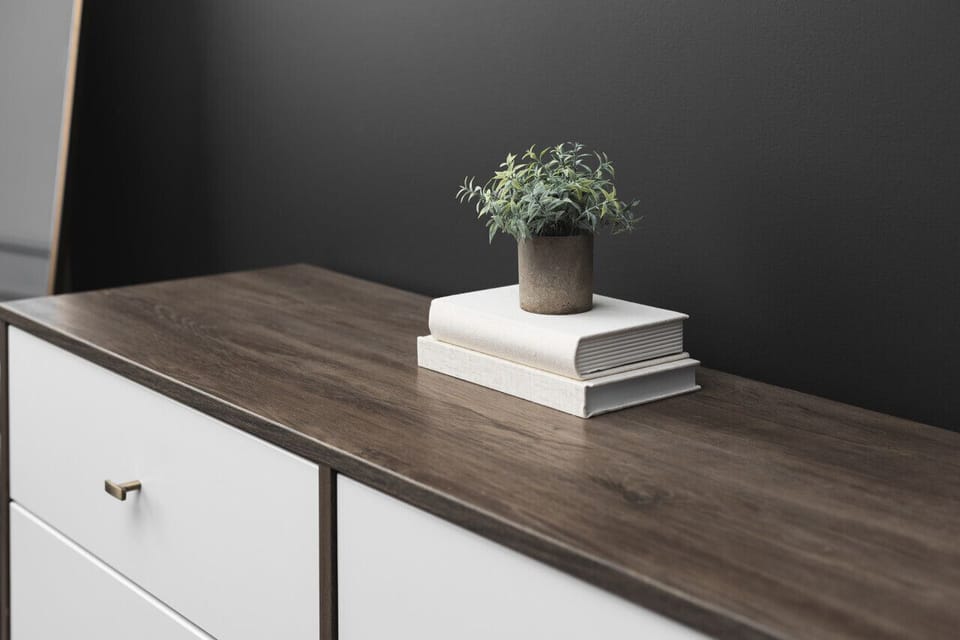 Spacious, comfortable king bed in the primary bedroom with a full-length mirror and ensuite bathroom.