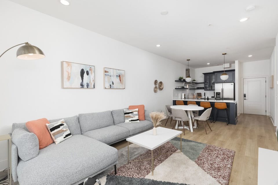 Our cozy living room is a great place to kick back - comfortable sectional sofa with a Smart TV + all the streaming apps and a balcony providing fresh air & natural light. Designed with your comfort & ease in mind.