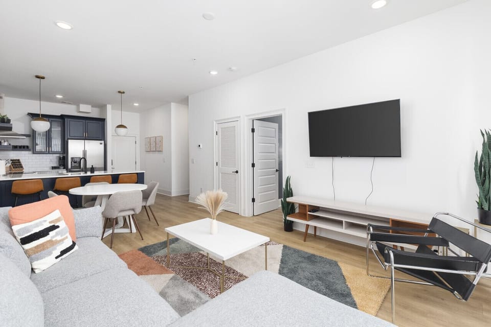 Our cozy living room is a great place to kick back - comfortable sectional sofa with a Smart TV + all the streaming apps and a balcony providing fresh air & natural light. Designed with your comfort & ease in mind.