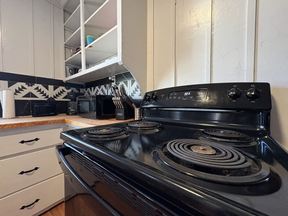 Fully equipped kitchen with electric stove