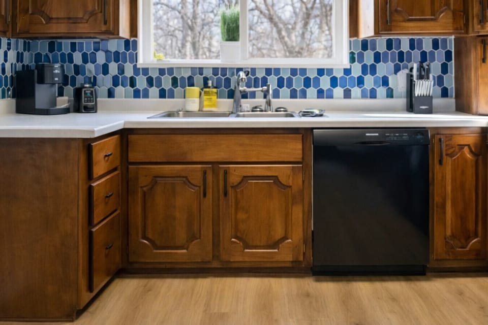 Kitchen with sink, dishwasher, and modern backsplash