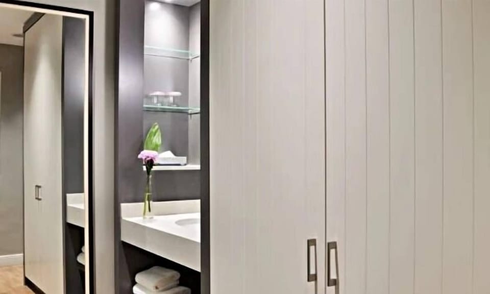 Freshen up effortlessly at the sleek vanity with plush towels.