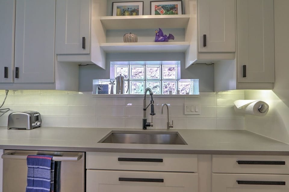 Modern kitchen with sleek counters and new stainless appliances