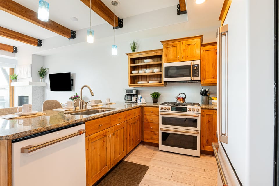 Fully equipped kitchen with white stainless steel GE Cafe appliances