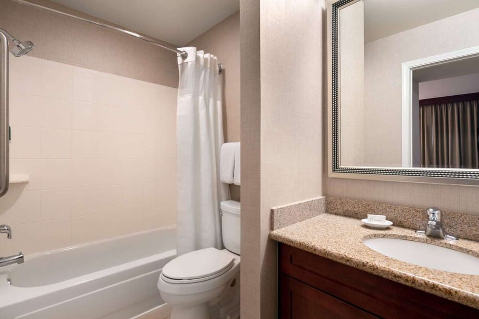 Refresh in a spotless bath with bright vanity lighting