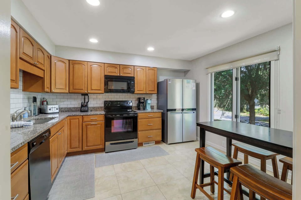 Kitchen is fully stocked with cookware and dishware