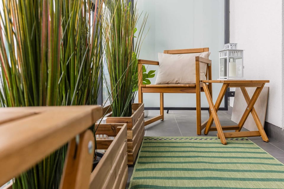 The furnished balcony offers a perfect spot for morning coffee with a view.