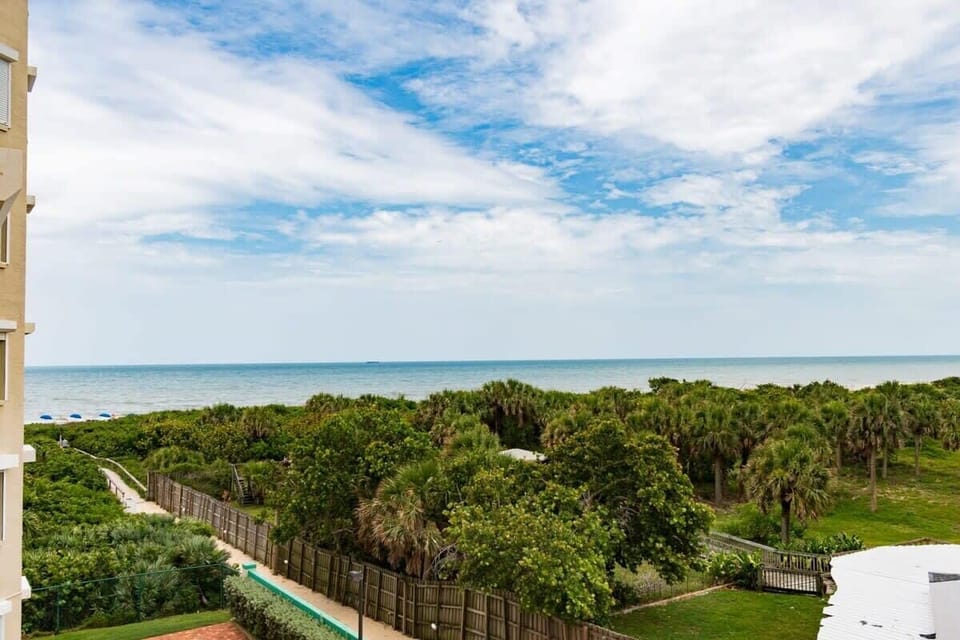Ocean view with lush greenery and a clear sky