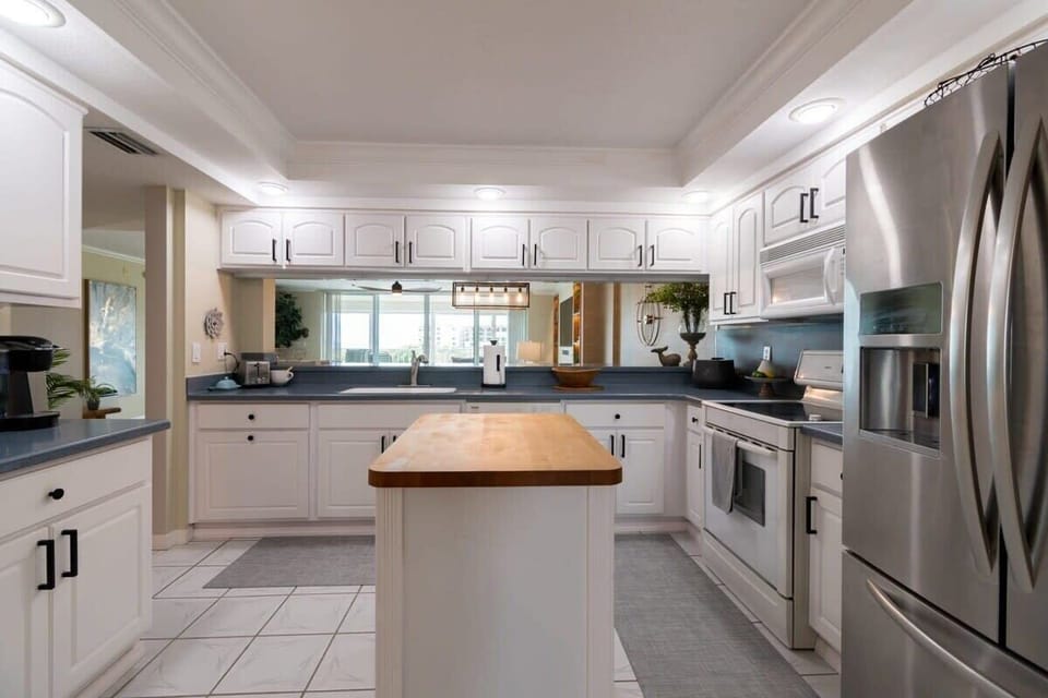 Modern kitchen with white cabinetry and stainless steel appliances