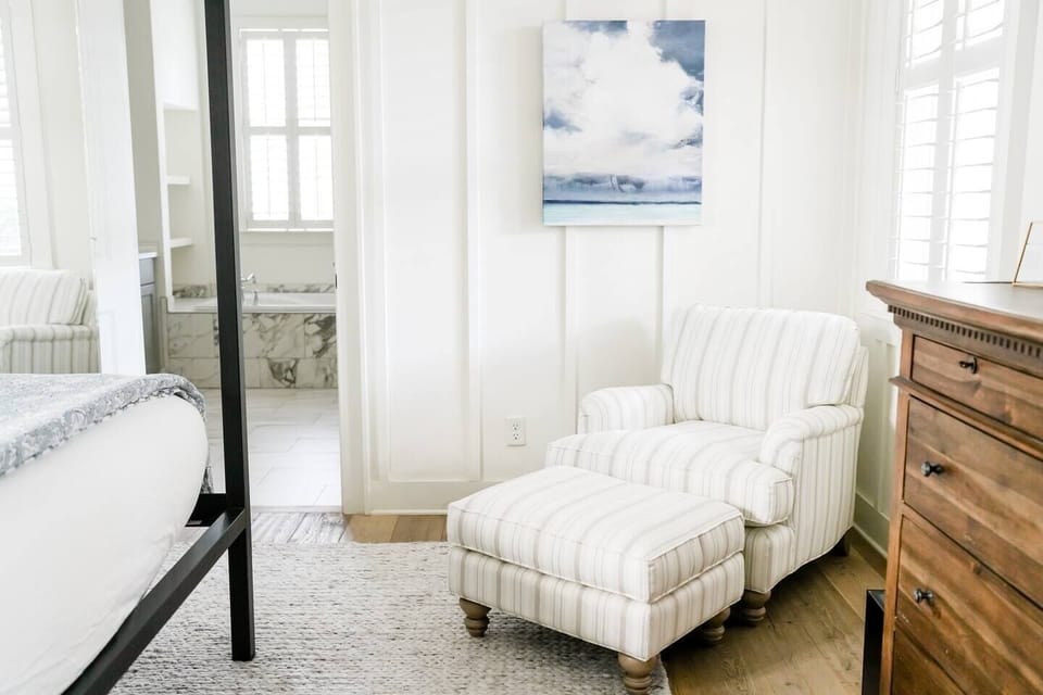 Primary bedroom. Curl up with a book or have your morning coffee in this cozy chair. 