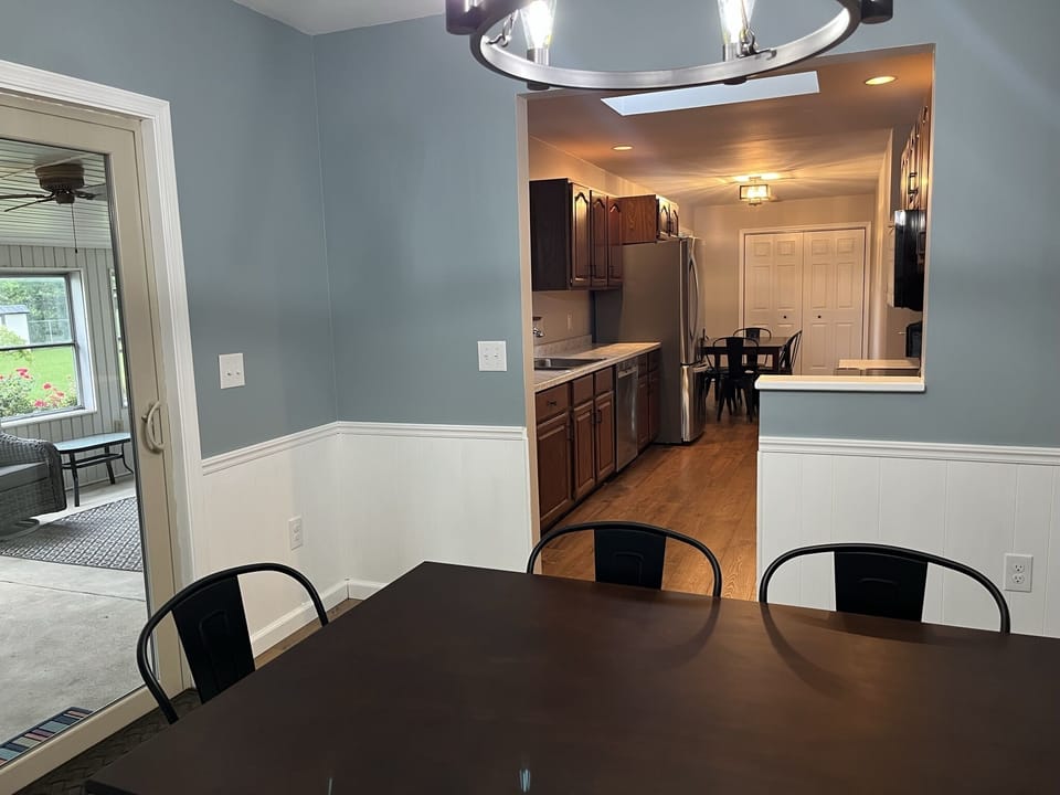 Dining room with seating for 6 and access to the sun porch and pool area.