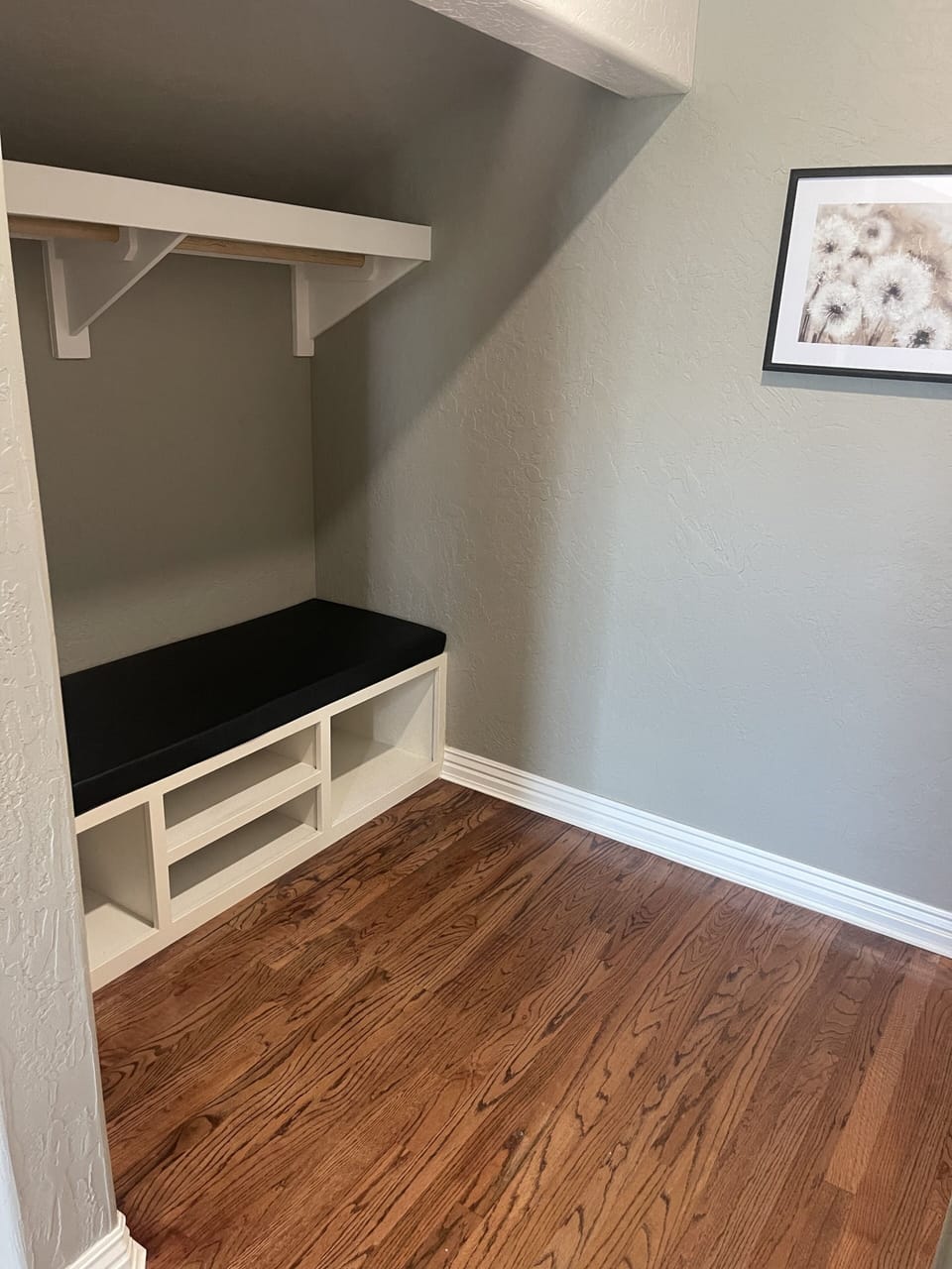 Upstairs open closet with bench